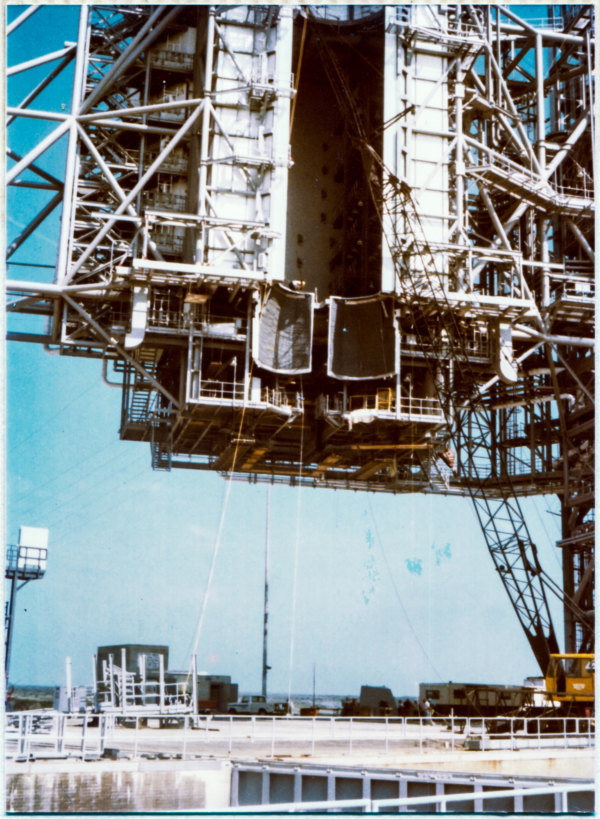 Image 069. The Rotating Service Structure at Space Shuttle Launch Complex 39-B, Kennedy Space Center, Florida, shortly after the new OMS Pod Heated Purge Covers had been installed, showing preparatory work for the installation of the ARCS Rooms underway, in addition to no end of other unseen preparations by Union Ironworkers from Local 808 for the huge grab bag of removals, modifications, and additions on both the RSS and the FSS which were encompassed by Engineering Drawing Package 79K24048. Photo by James MacLaren.